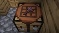 An axe placed on a crafting table with the help of the invisible item frame (Image via Minecraft 1.19)
